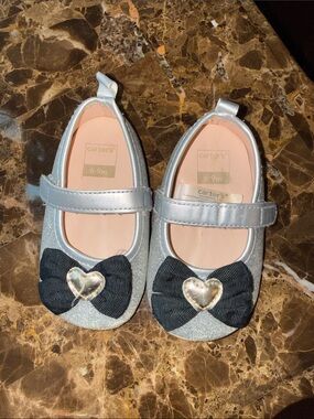Size 3/6-9 month baby girls soft sole sparkly silver shoes from Carter.